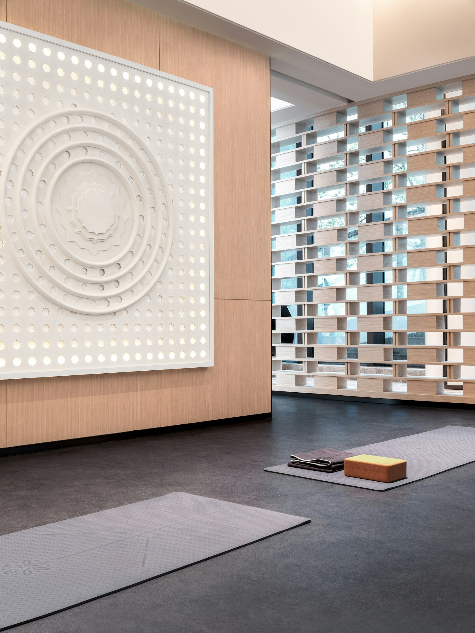 Yoga mats and equipment neatly arranged in a modern fitness studio