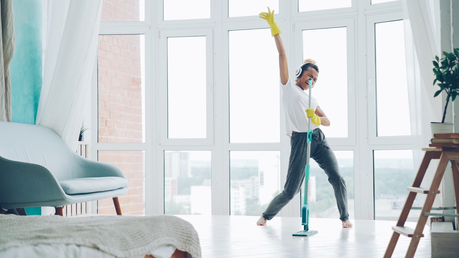Cleaner mopping a floor in a modern interior